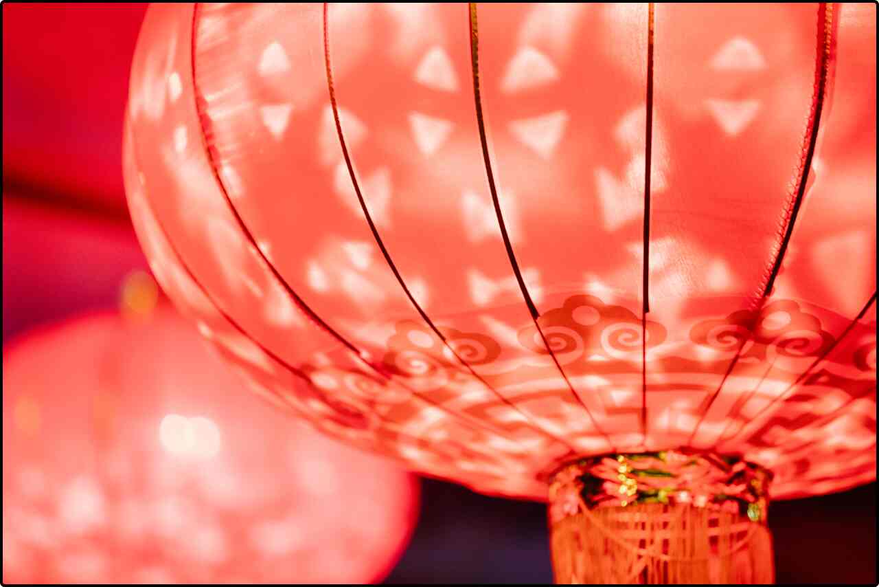 Close-up of a radiant red lantern, enhancing the ambiance of a traditional event.